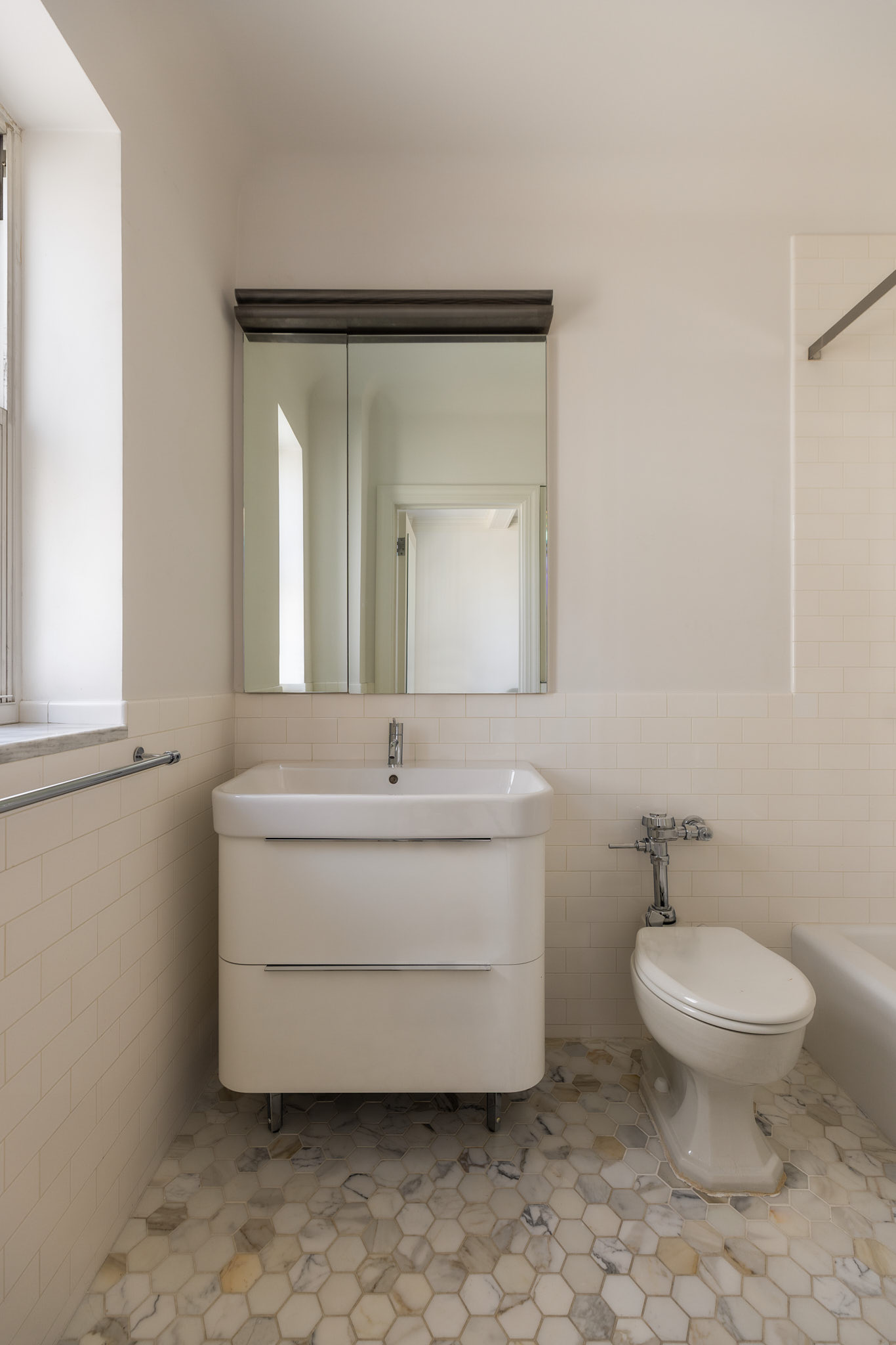 25 East End Avenue, Unit 11E Manhattan, NY 10075 - Photo 16 of 19 a bathroom with a toilet sink and mirror