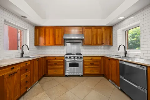 a kitchen with stainless steel appliances a stove sink and cabinets