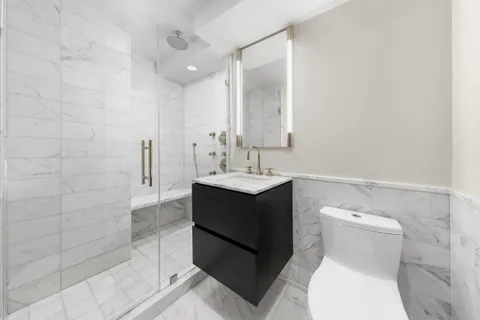 a bathroom with a sink toilet and shower