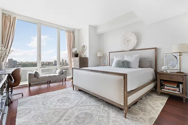 60 Riverside Boulevard, Unit 3003 Manhattan, NY 10069 - Photo 2 of 17 a bed room with a bed and a couch