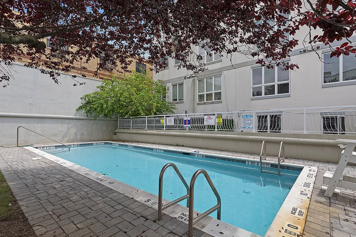 3112 Emmons Avenue, Unit 305 Brooklyn, NY 11235 - Photo 7 of 9 a swimming pool with outdoor seating and yard