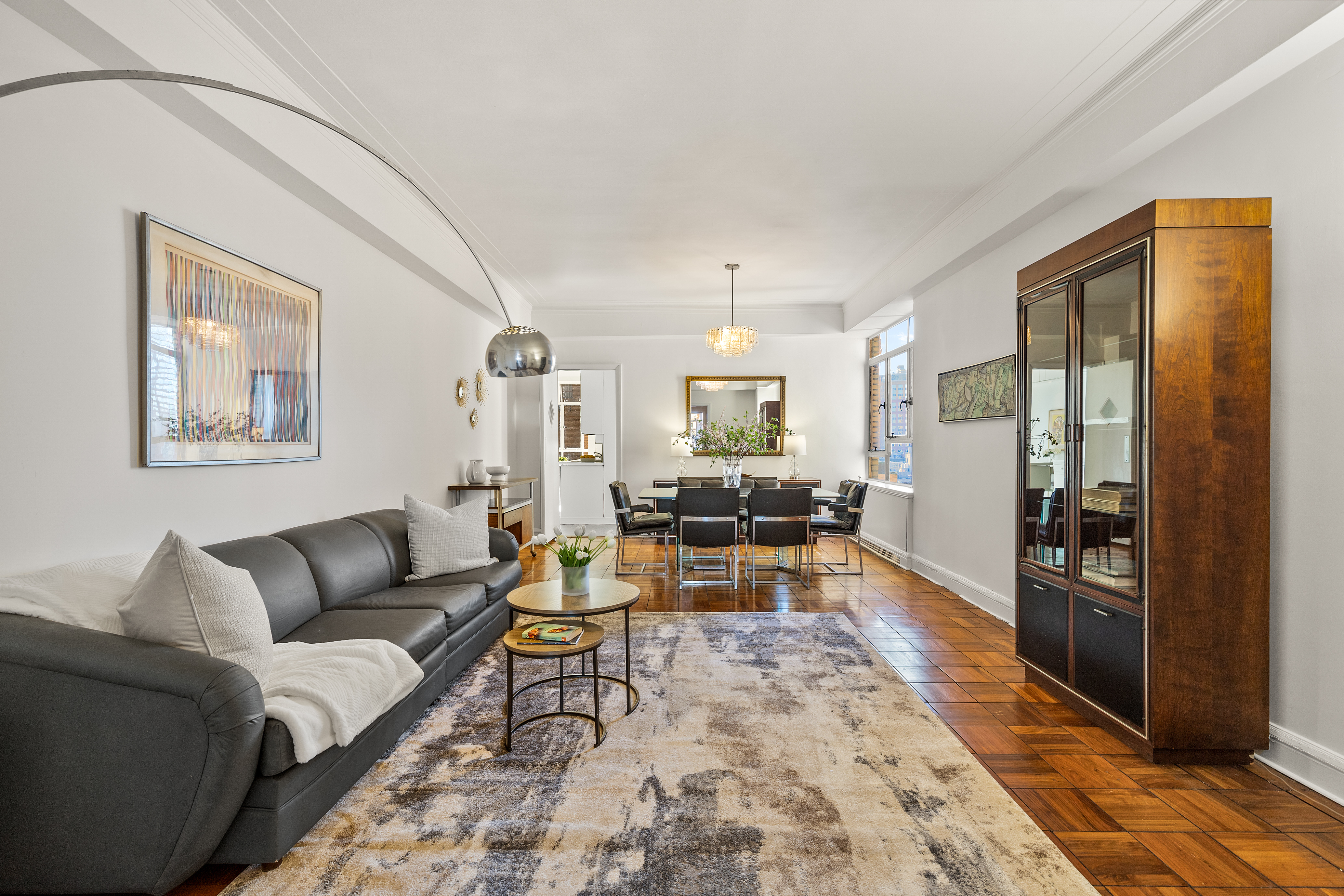 115 Central Park West, Unit 16H Manhattan, NY 10023 - Photo 12 of 30 a living room with furniture a rug and kitchen view