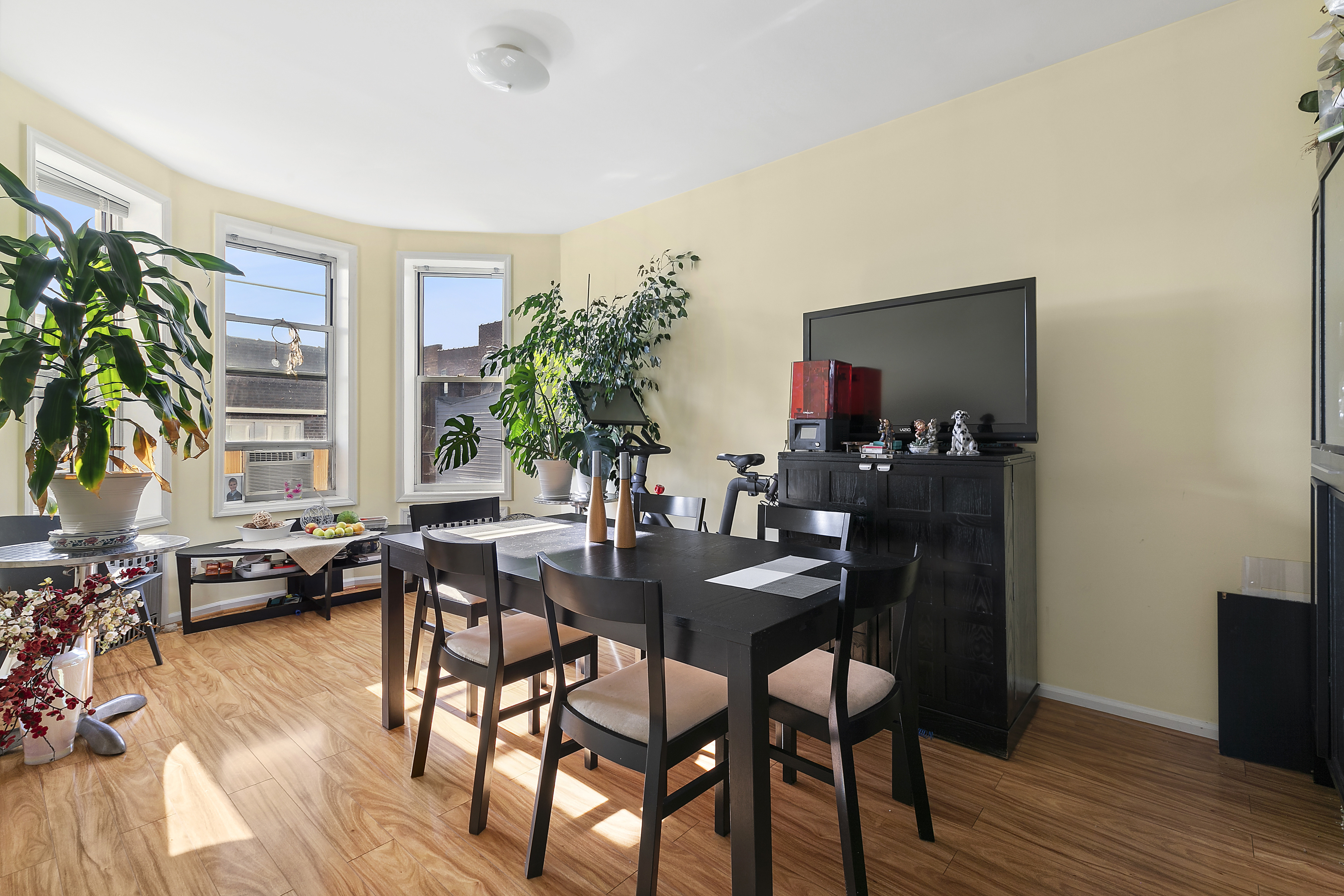 60-38 68th Road Queens, NY 11385 - Photo 5 of 14 a view of a livingroom and dining room with furniture window and wooden floor