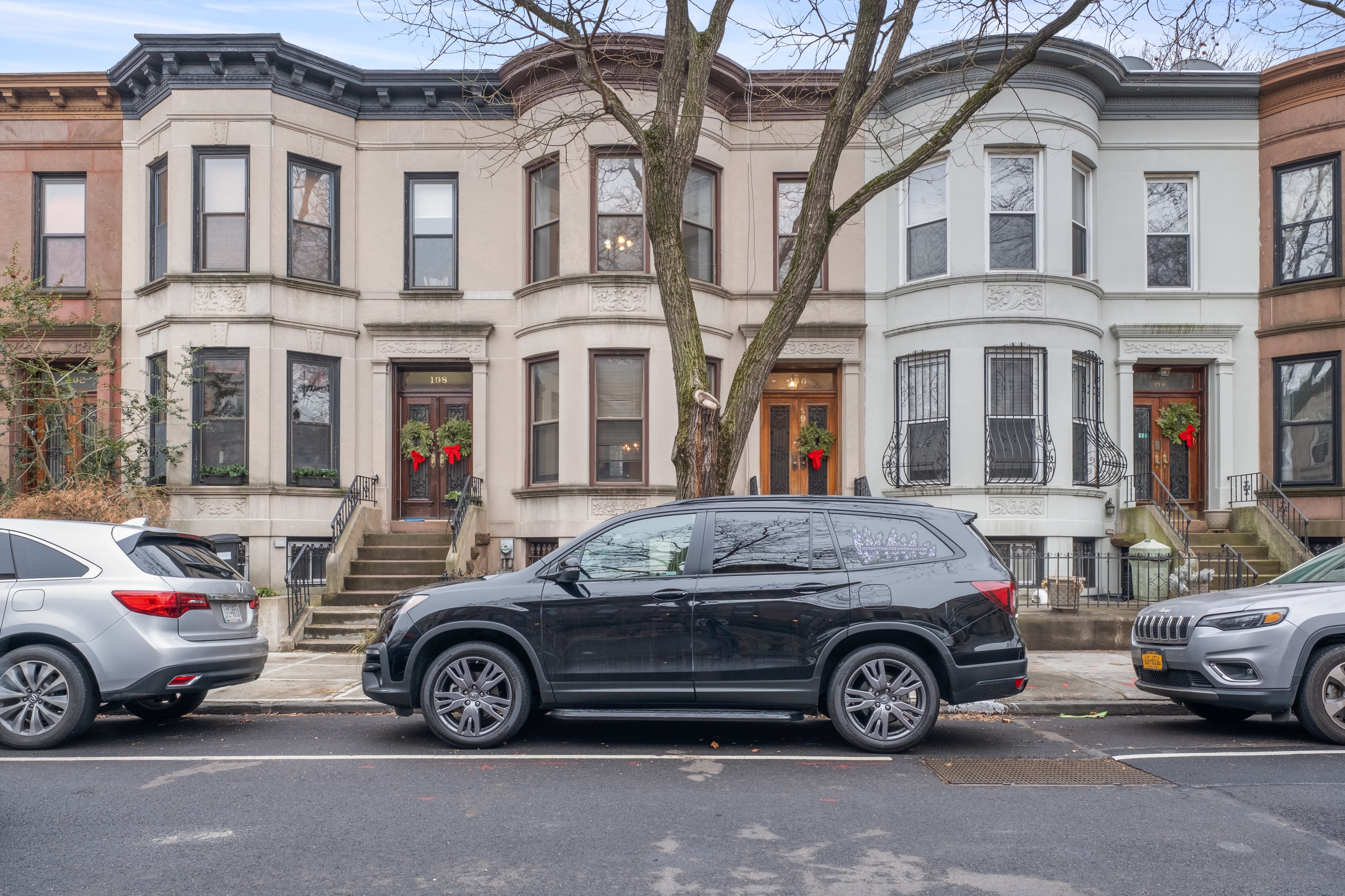 196 Maple Street Brooklyn, NY 11225 - Photo 27 of 31 a car parked in front of a white house
