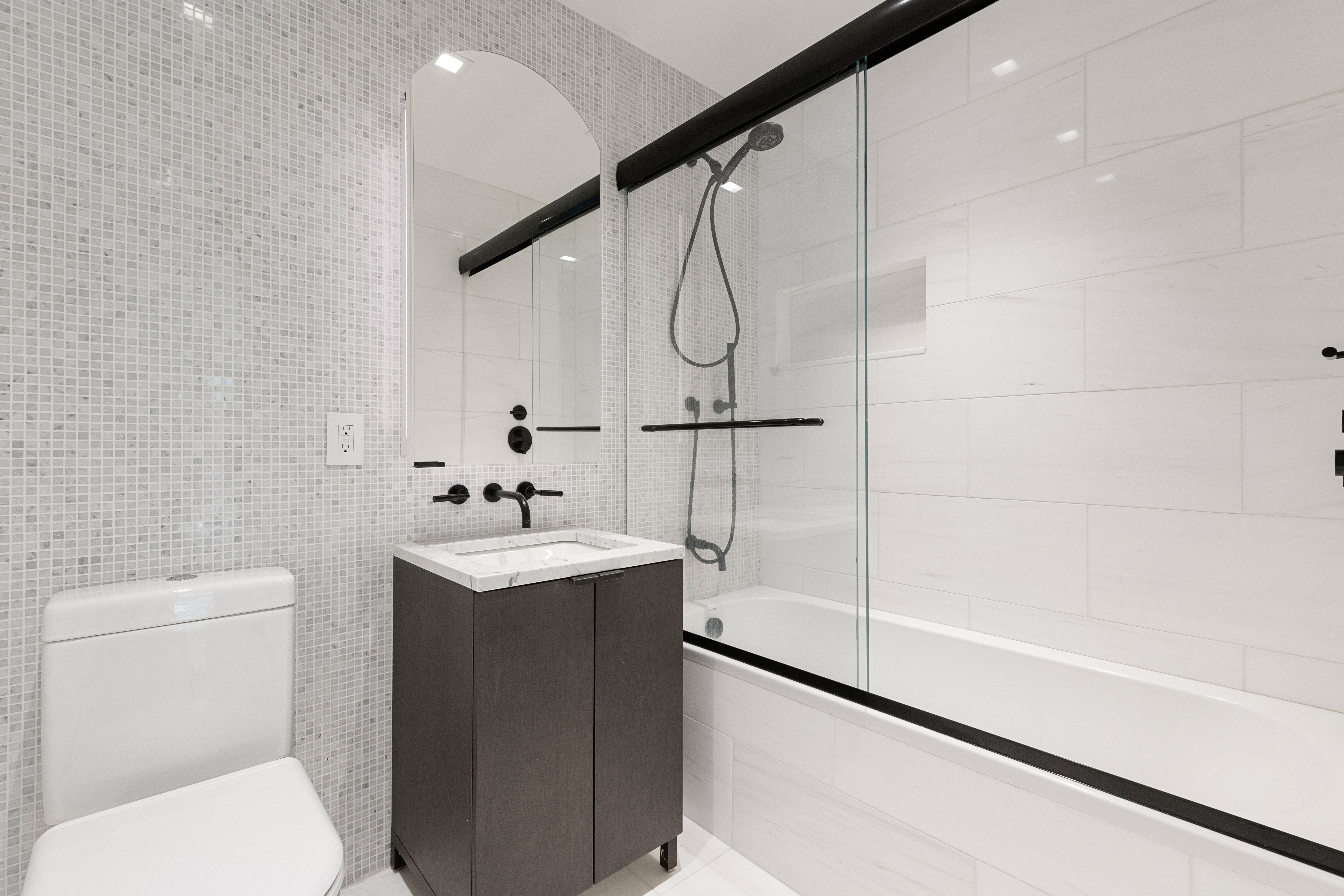 55 West 17th Street, Unit 403 Manhattan, NY 10011 - Photo 7 of 8 a bathroom with a sink a toilet and shower