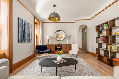 a living room with furniture and a book shelf