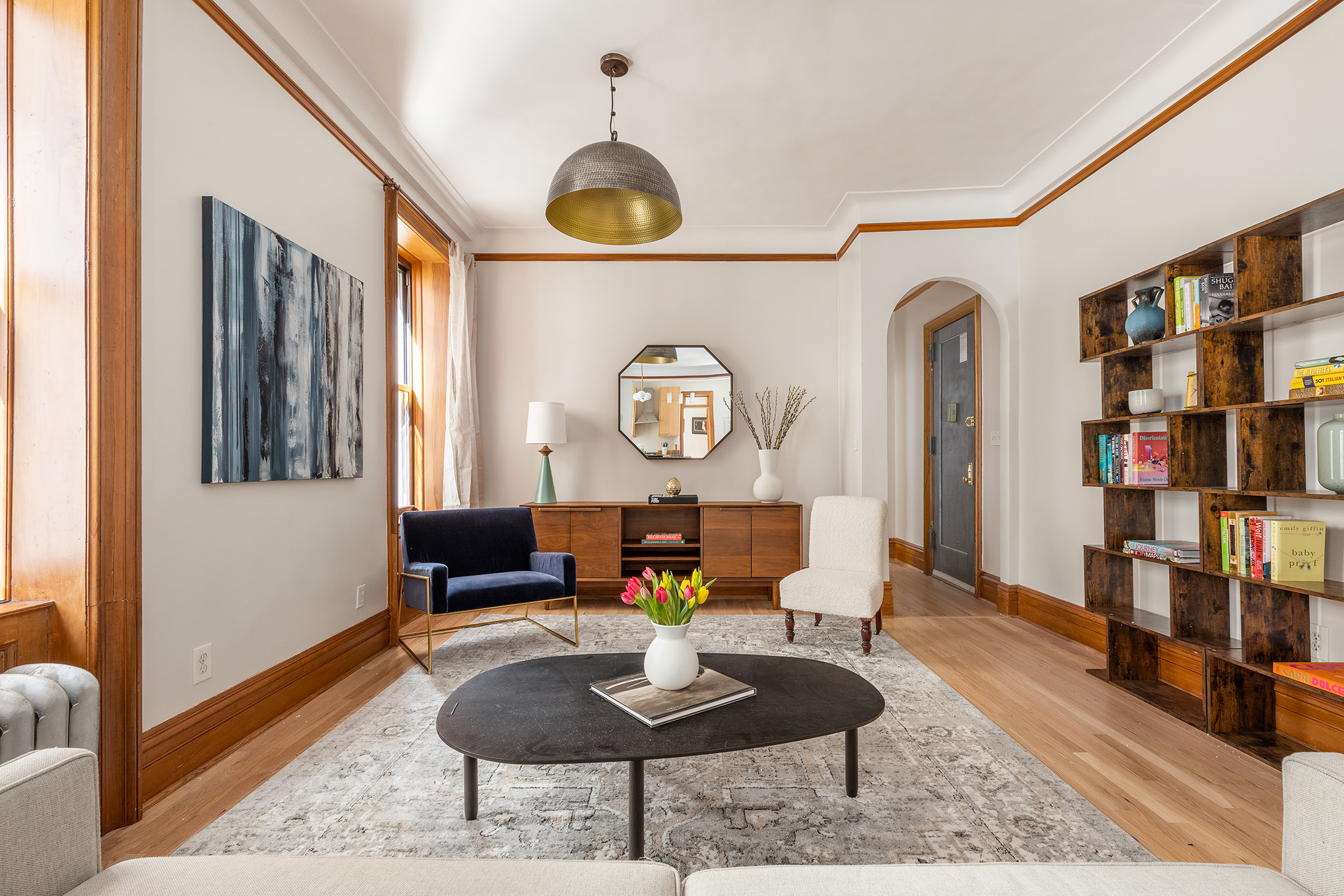 790 Riverside Drive, Unit 4C Manhattan, NY 10032 - Photo 2 of 11 a living room with furniture and a book shelf