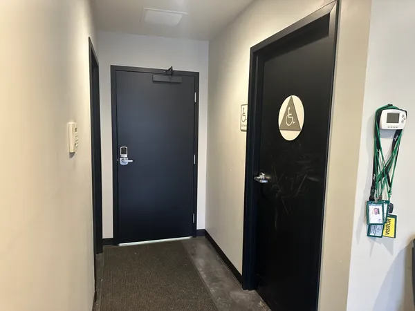 a view of a hallway with wooden door