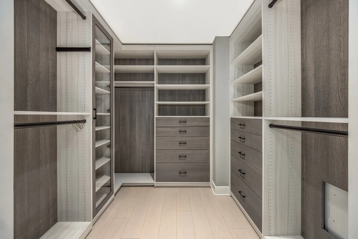 a view of walk in closet with empty racks