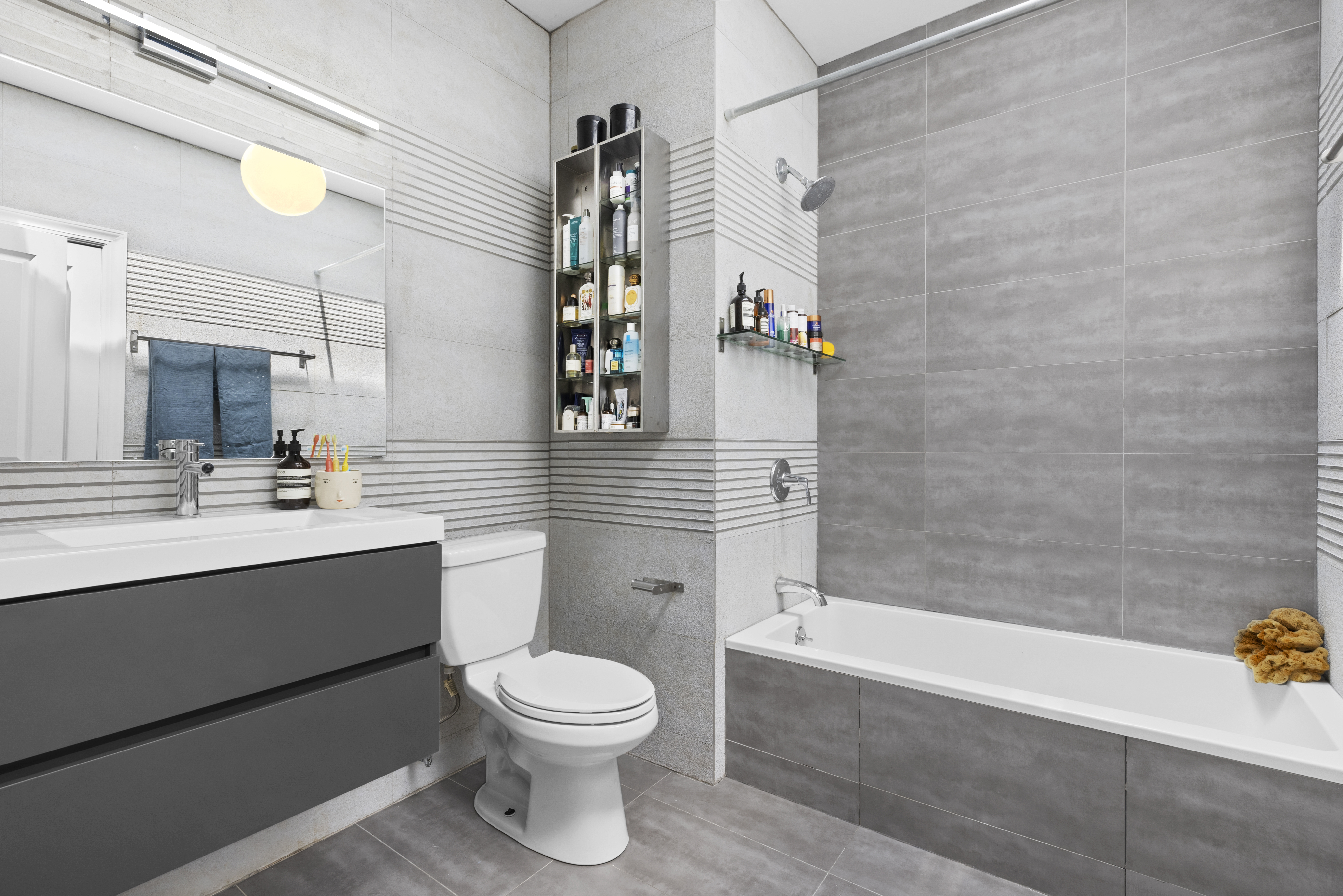 778 Hancock Street, Unit 2 Brooklyn, NY 11233 - Photo 7 of 11 a bathroom with a sink a toilet and shower