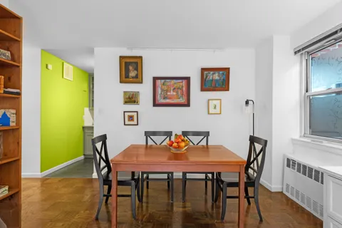 a view of a dining room with furniture and a window