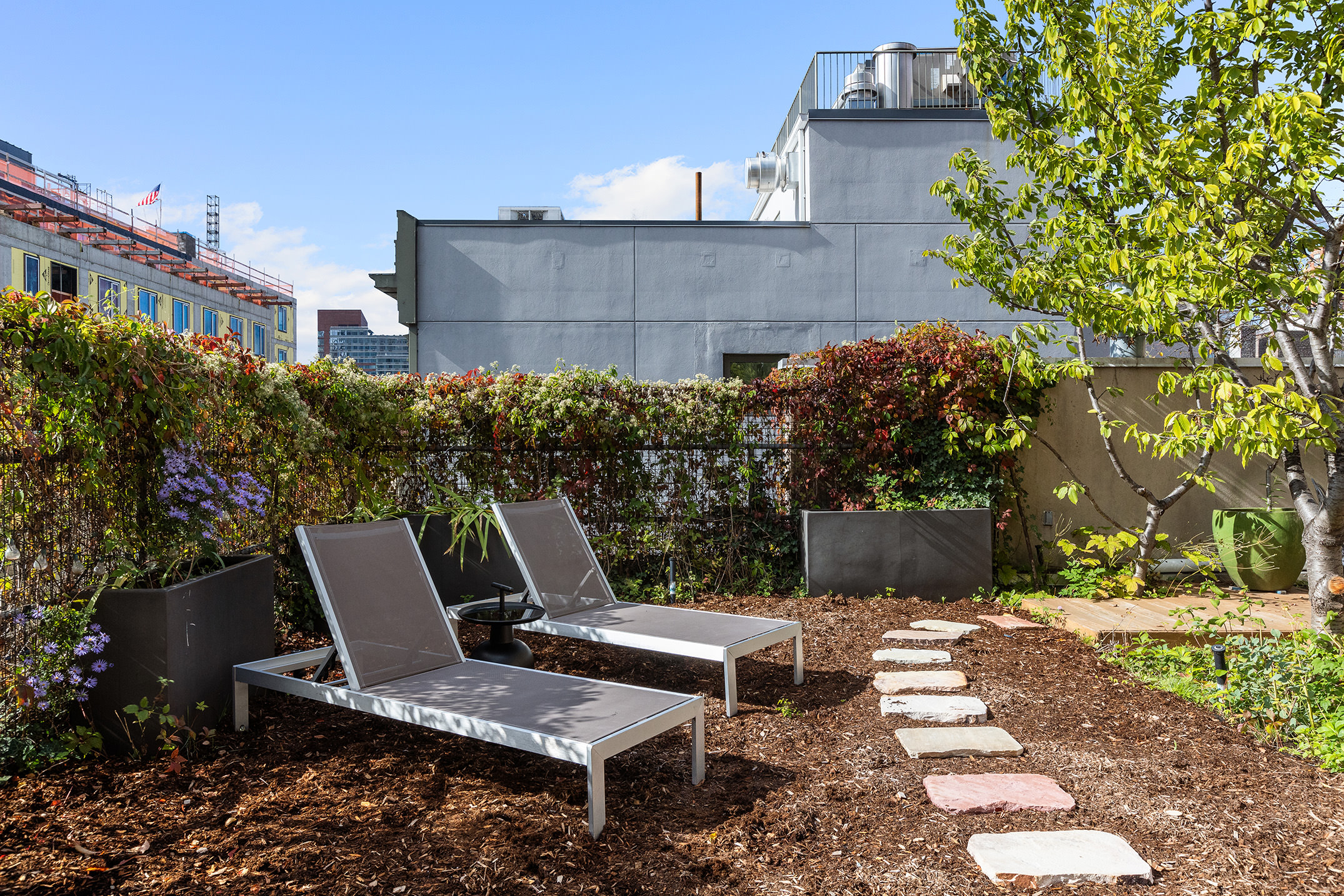 345 West 54th Street Manhattan, NY 10019 - Photo 15 of 22 a view of a patio with table and chairs and potted plants