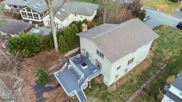 an aerial view of residential houses with outdoor space and lake view