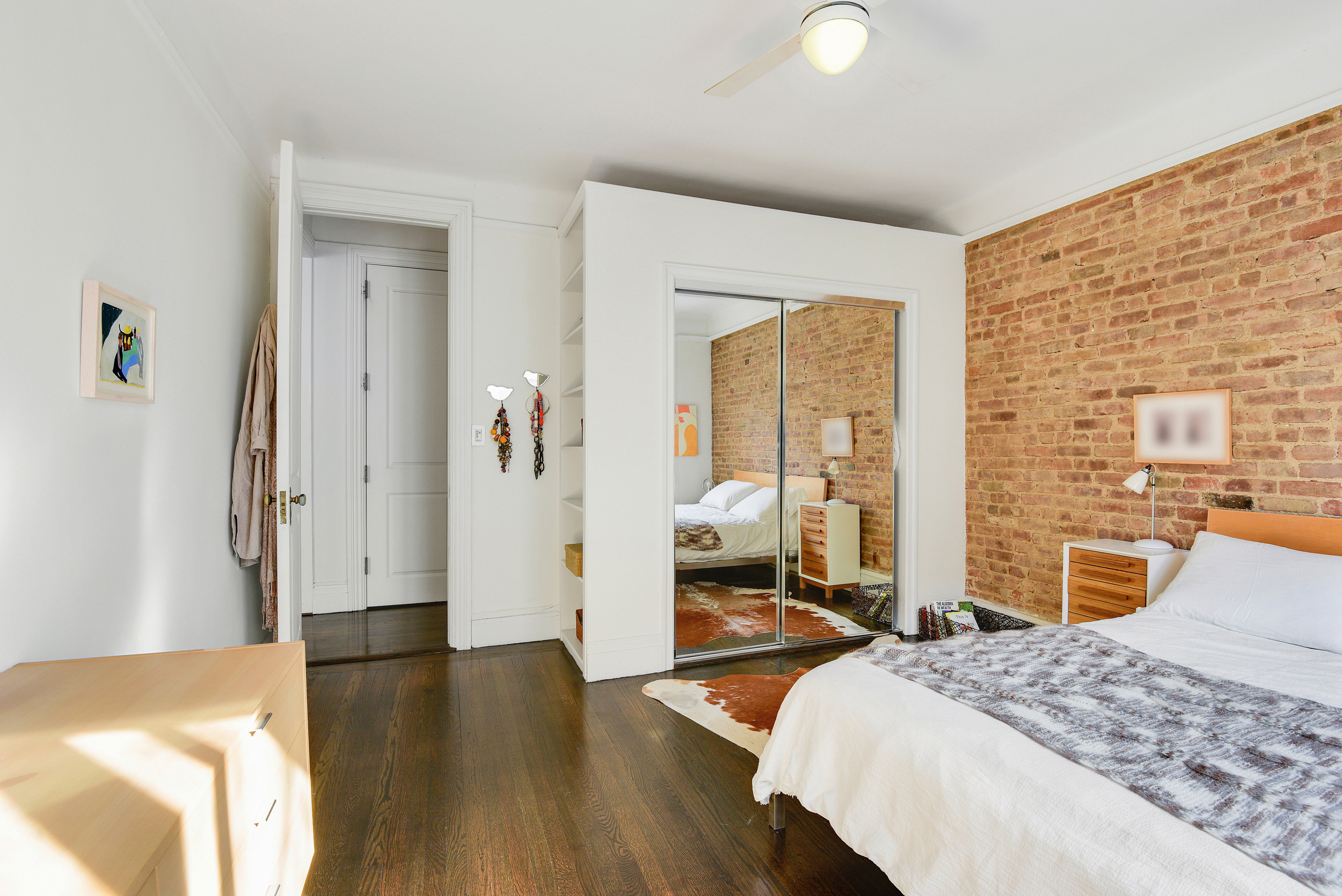 253 West 16th Street, Unit 3A Manhattan, NY 10011 - Photo 9 of 13 a bedroom with a bed and wooden floor