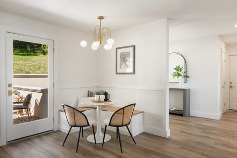 a view of a dining room with furniture and wooden floor