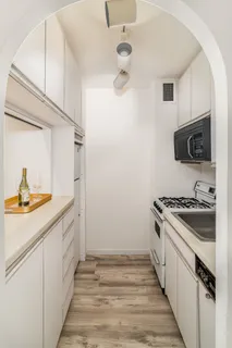 a kitchen with a sink and a stove top oven