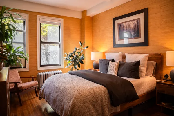 a bedroom with a bed and a painting on the wall