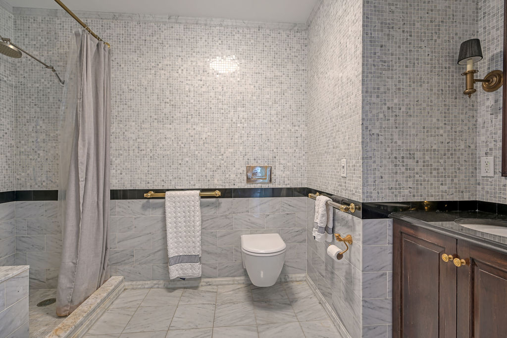 200 East 69th Street, Unit 21C Manhattan, NY 10021 - Photo 12 of 16 a bathroom with a granite countertop shower and a toilet