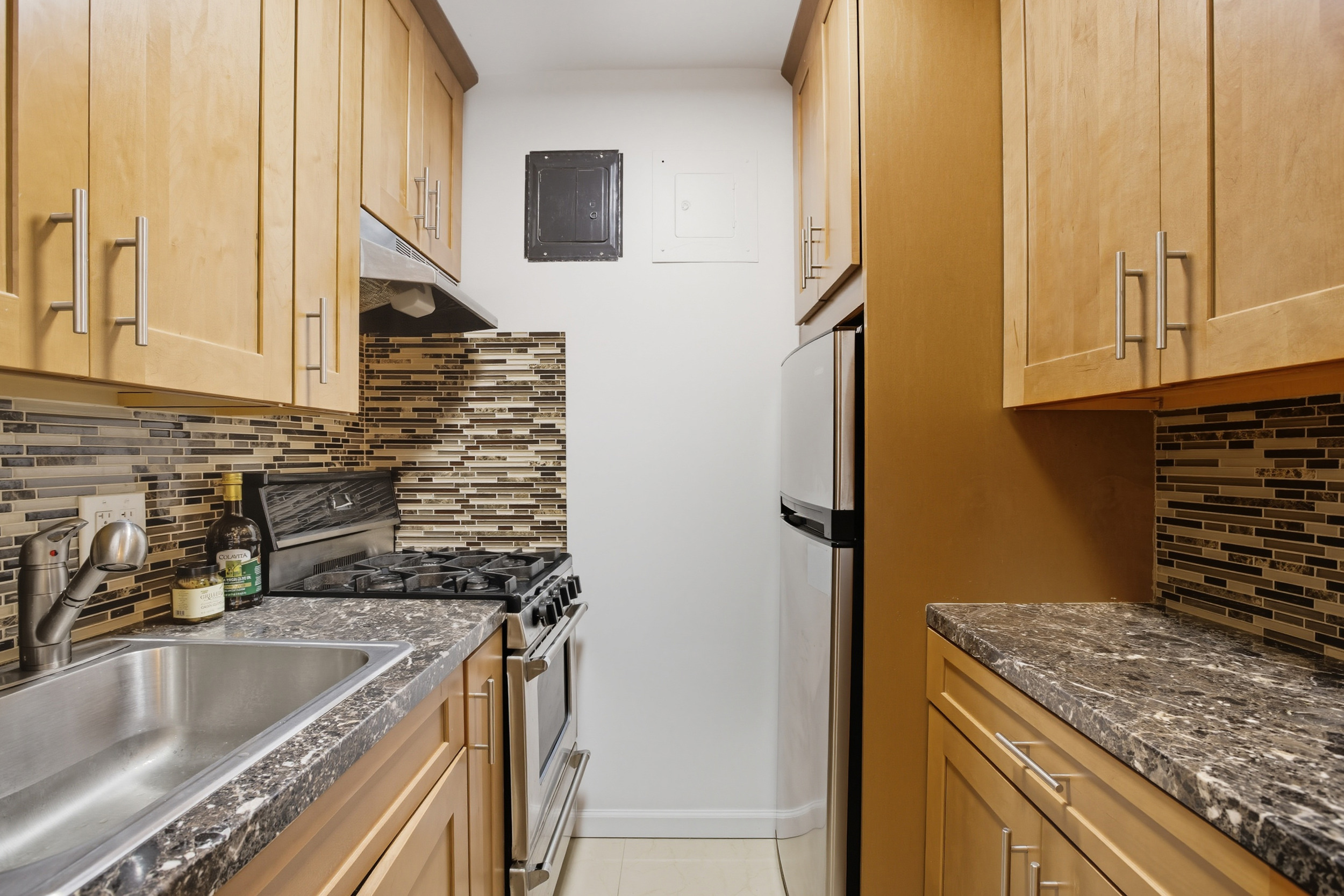 130 Hicks Street, Unit 1E Brooklyn, NY 11201 - Photo 7 of 12 a kitchen with granite countertop a sink and a stove top oven