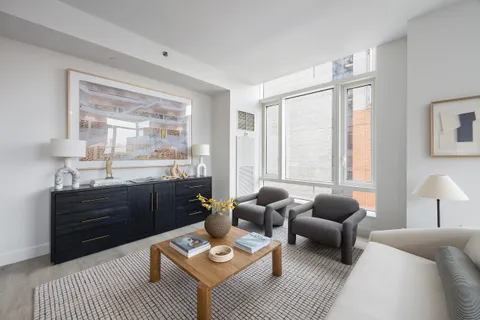 a living room with furniture rug and window