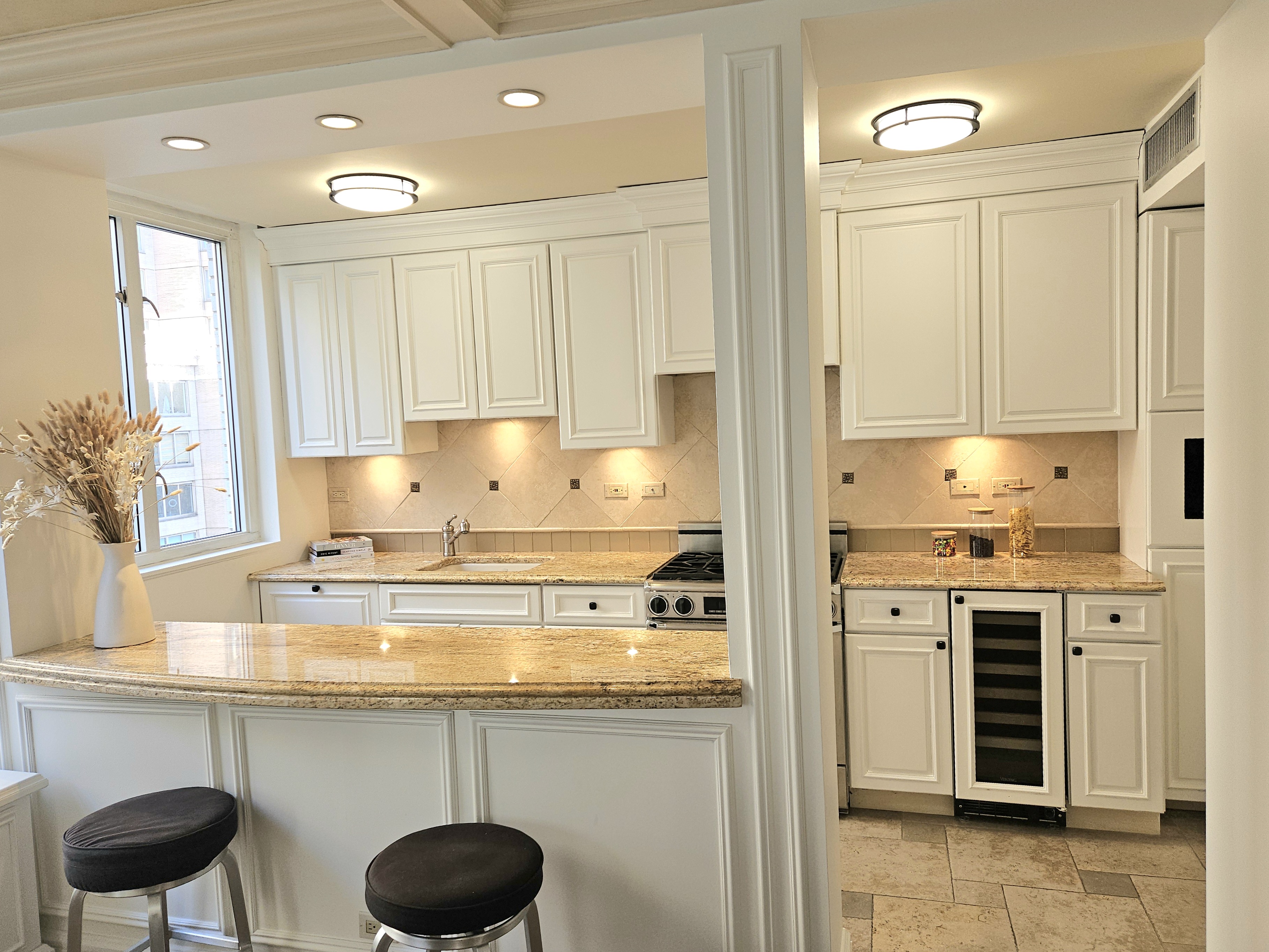 169 East 69th Street, Unit 7/8 B Manhattan, NY 10021 - Photo 9 of 30 a kitchen with stainless steel appliances granite countertop a stove and a refrigerator