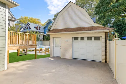 a view of a house with a backyard and a garage