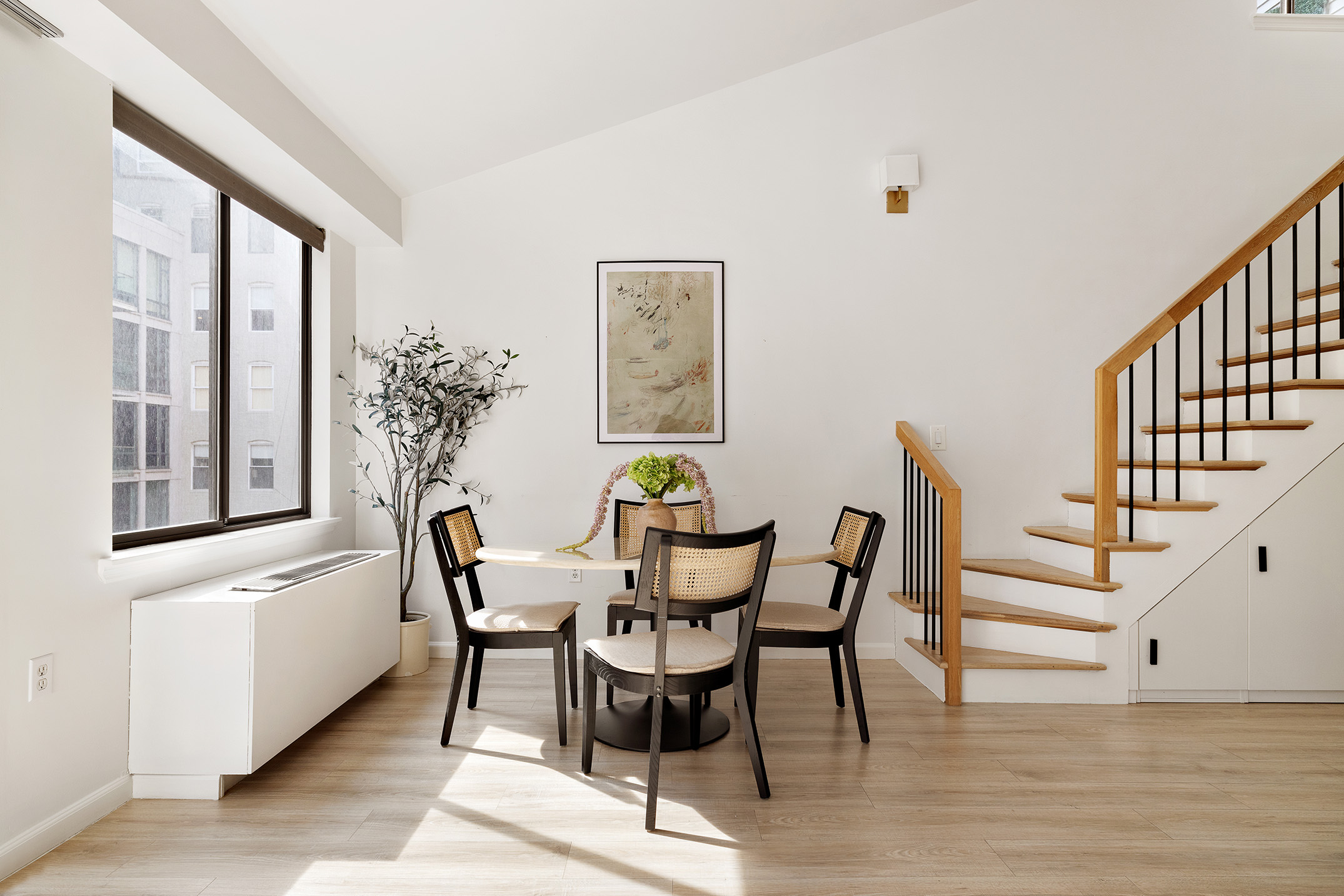 136-140 West 23rd Street, Unit PHD Manhattan, NY 10011 - Photo 6 of 15 a view of a dining room with furniture window and wooden floor