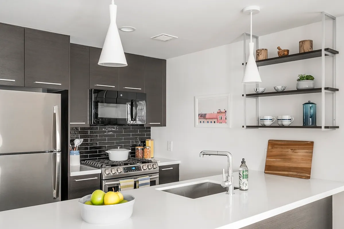 a kitchen with stainless steel appliances a sink and a refrigerator