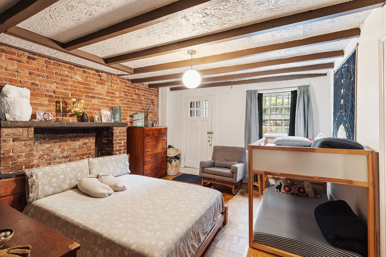 a bedroom with furniture and a wooden floor