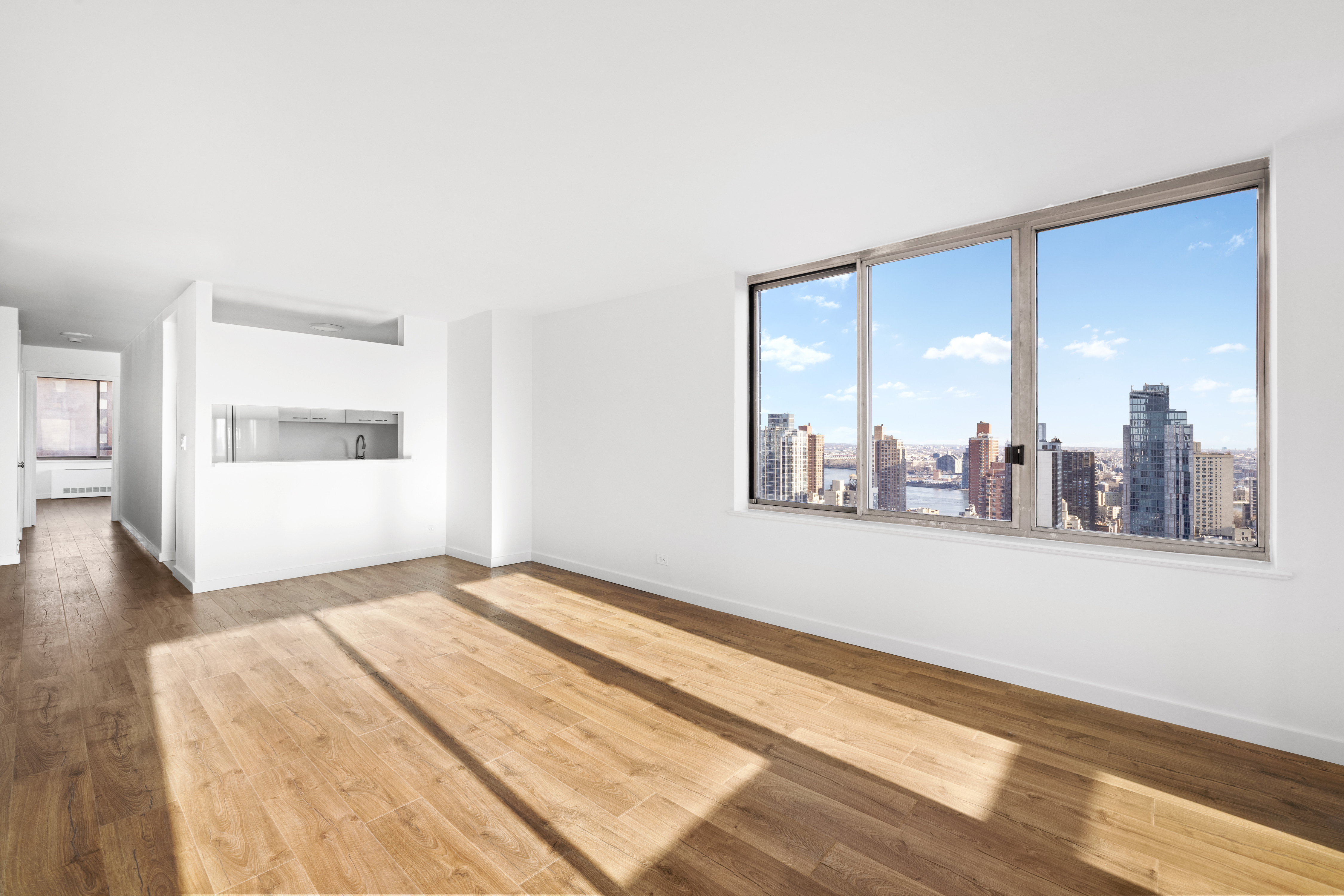 200 East 89th Street, Unit 29D Manhattan, NY 10128 - Photo 2 of 16 a view of a room with wooden floor and a window