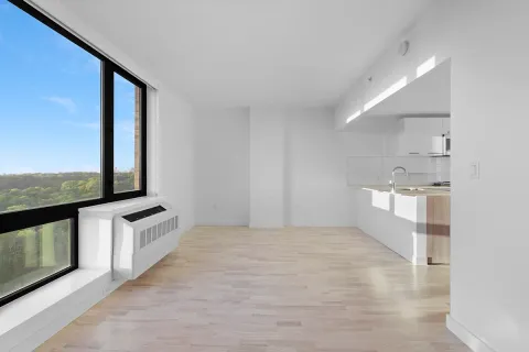 a view of a kitchen with stainless steel appliances wooden cabinets and a floor to ceiling window