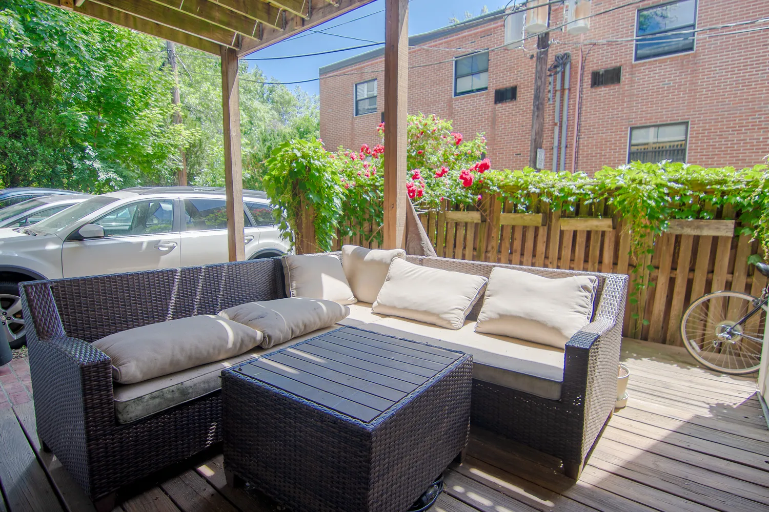 a view of a patio with couches table and chairs and potted plants