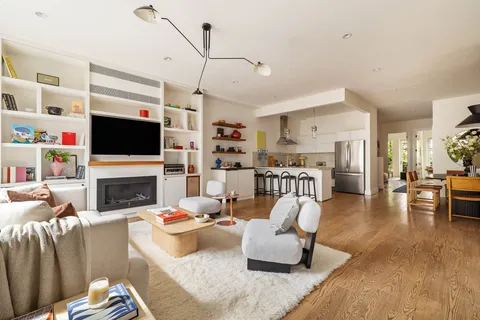 a living room with fireplace furniture and a flat screen tv