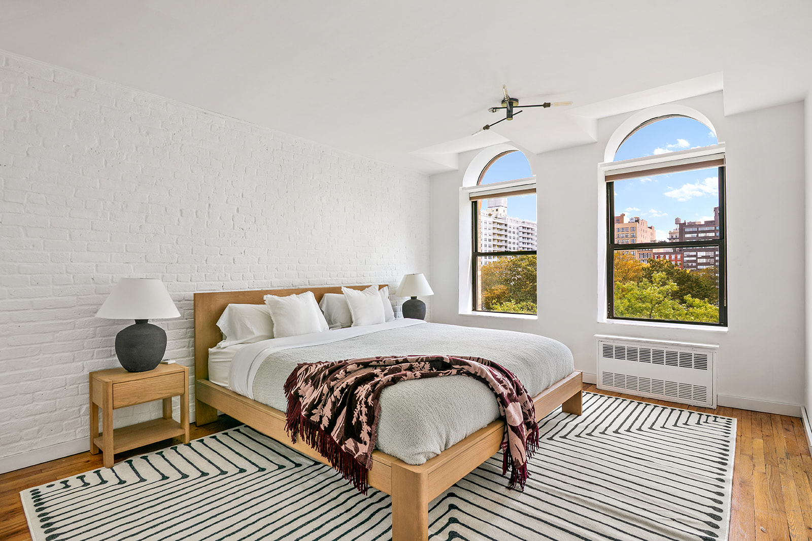 520 LaGuardia Place, Unit 6N Manhattan, NY 10012 - Photo 8 of 11 a bedroom with a bed and wooden floor