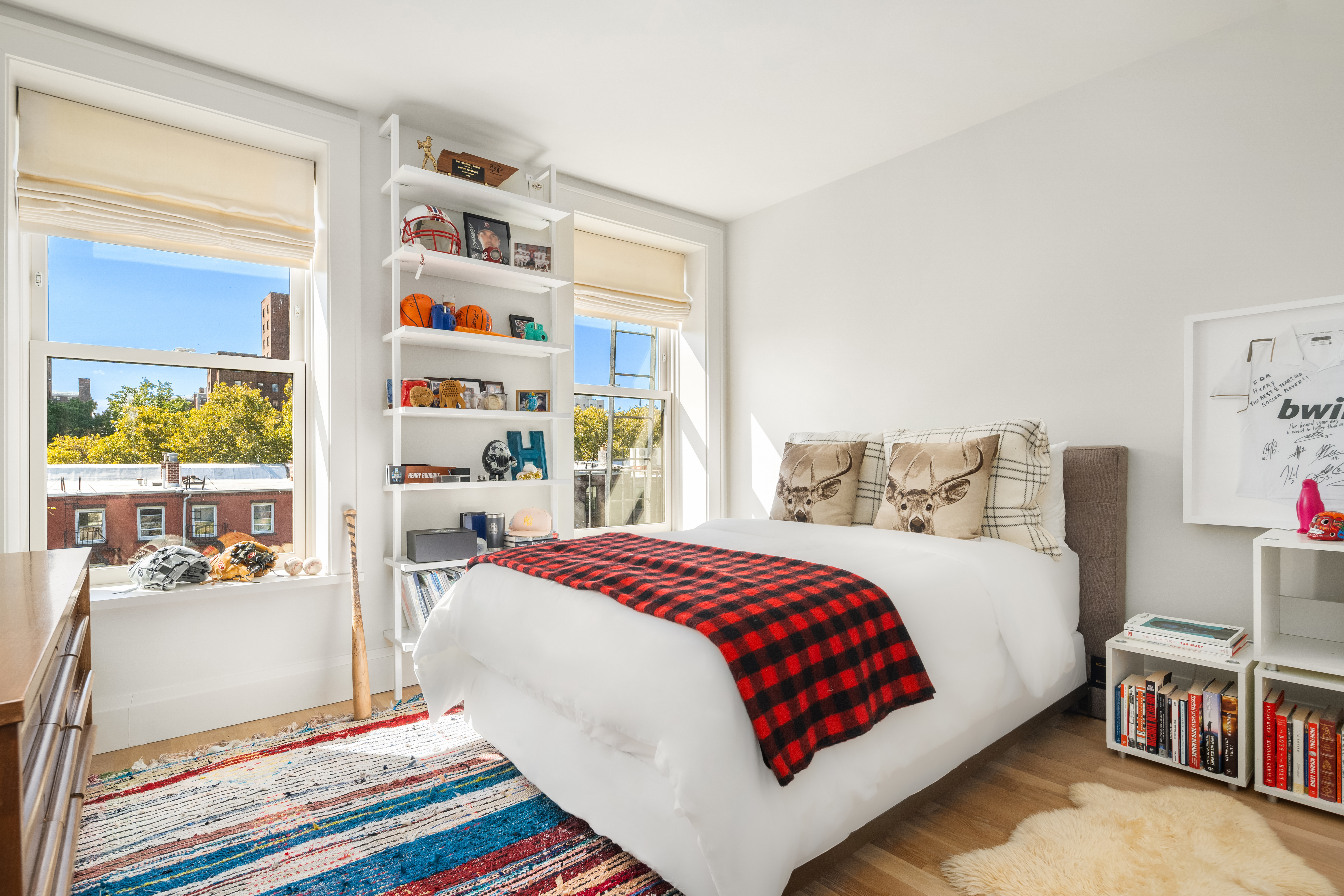 168 Bergen Street Brooklyn, NY 11217 - Photo 19 of 25 a bedroom with bed and a book shelf