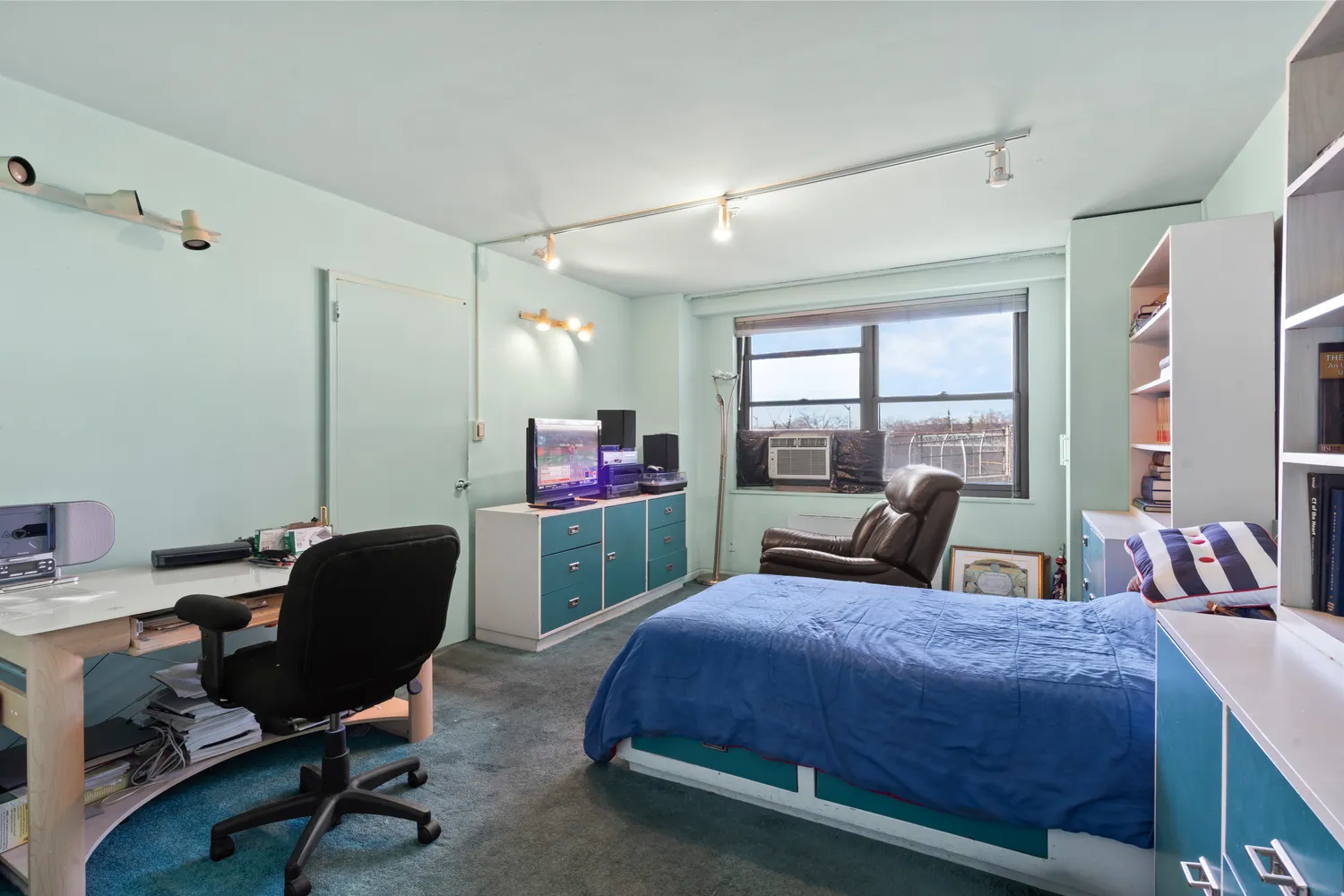 a bedroom with a bed chair and a window