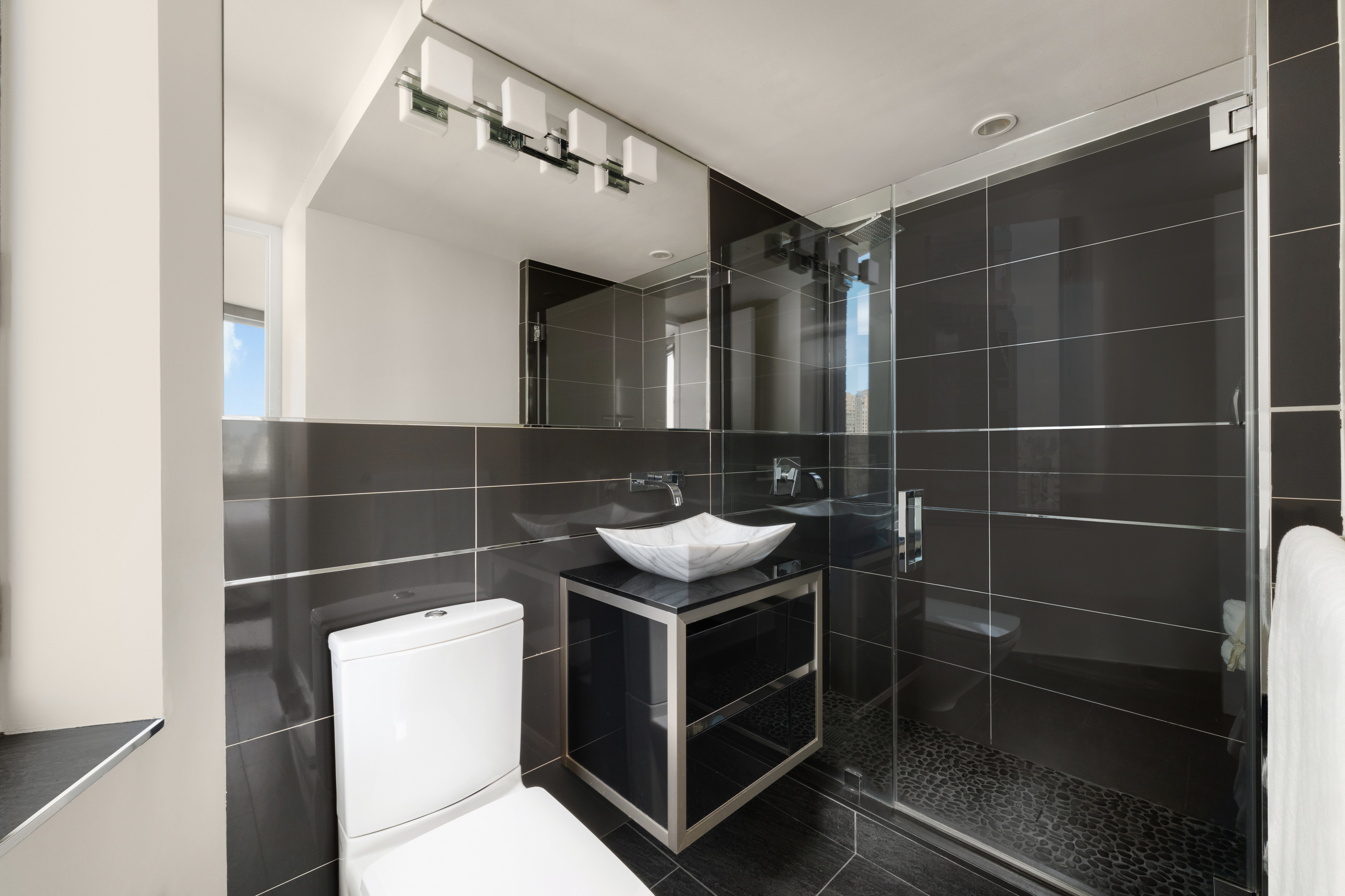 150 Columbus Avenue, Unit 22A Manhattan, NY 10023 - Photo 10 of 23 a bathroom with a sink toilet and shower