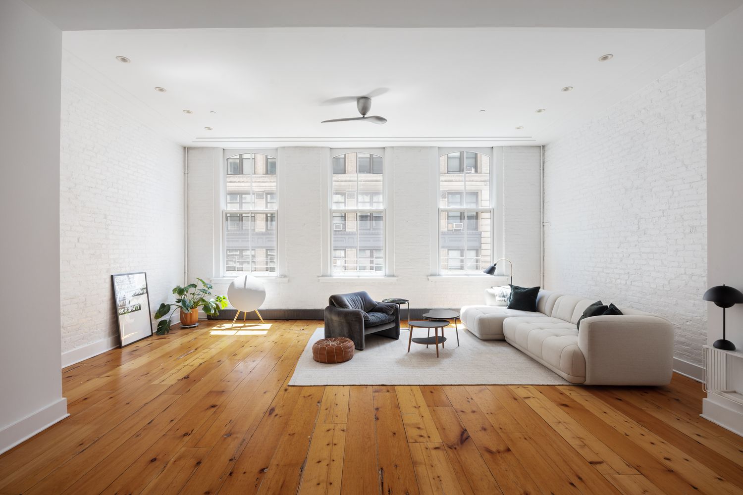 a living room with furniture window and wooden floor