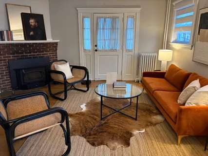 a living room with furniture and a fireplace