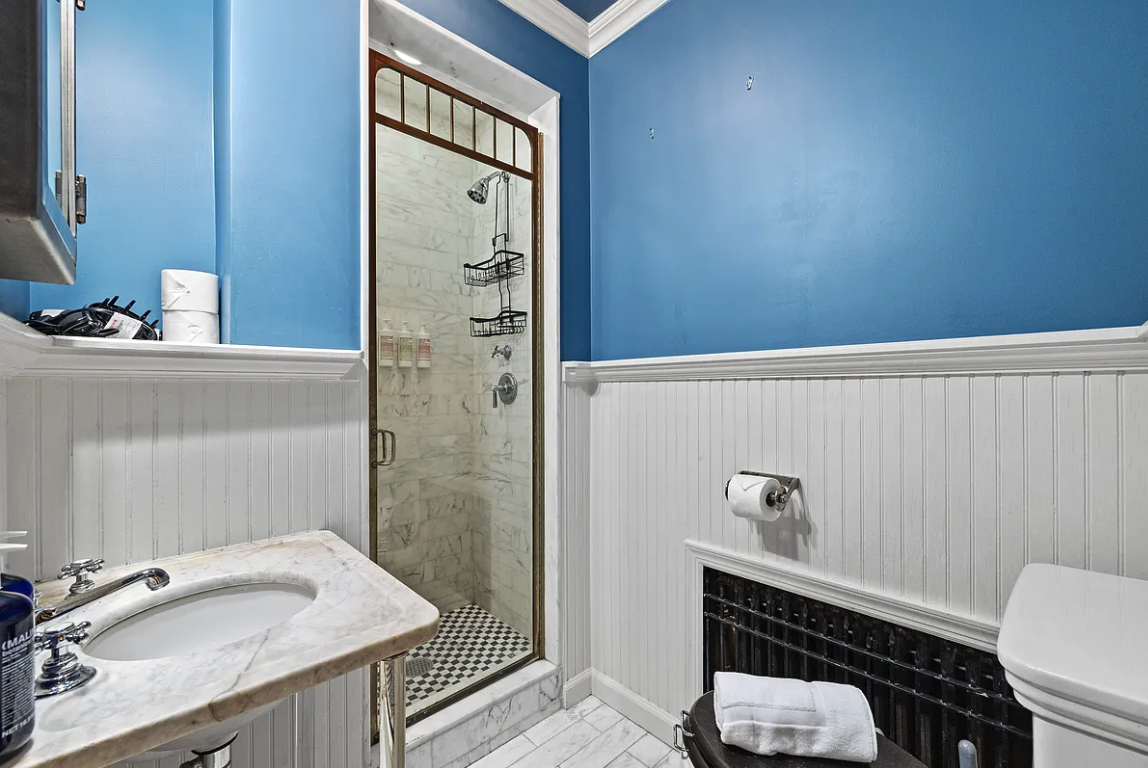 58 Downing Street Manhattan, NY 10014 - Photo 16 of 21 a bathroom with a sink toilet and shower