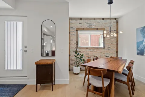 a dining room with a wooden table and chairs