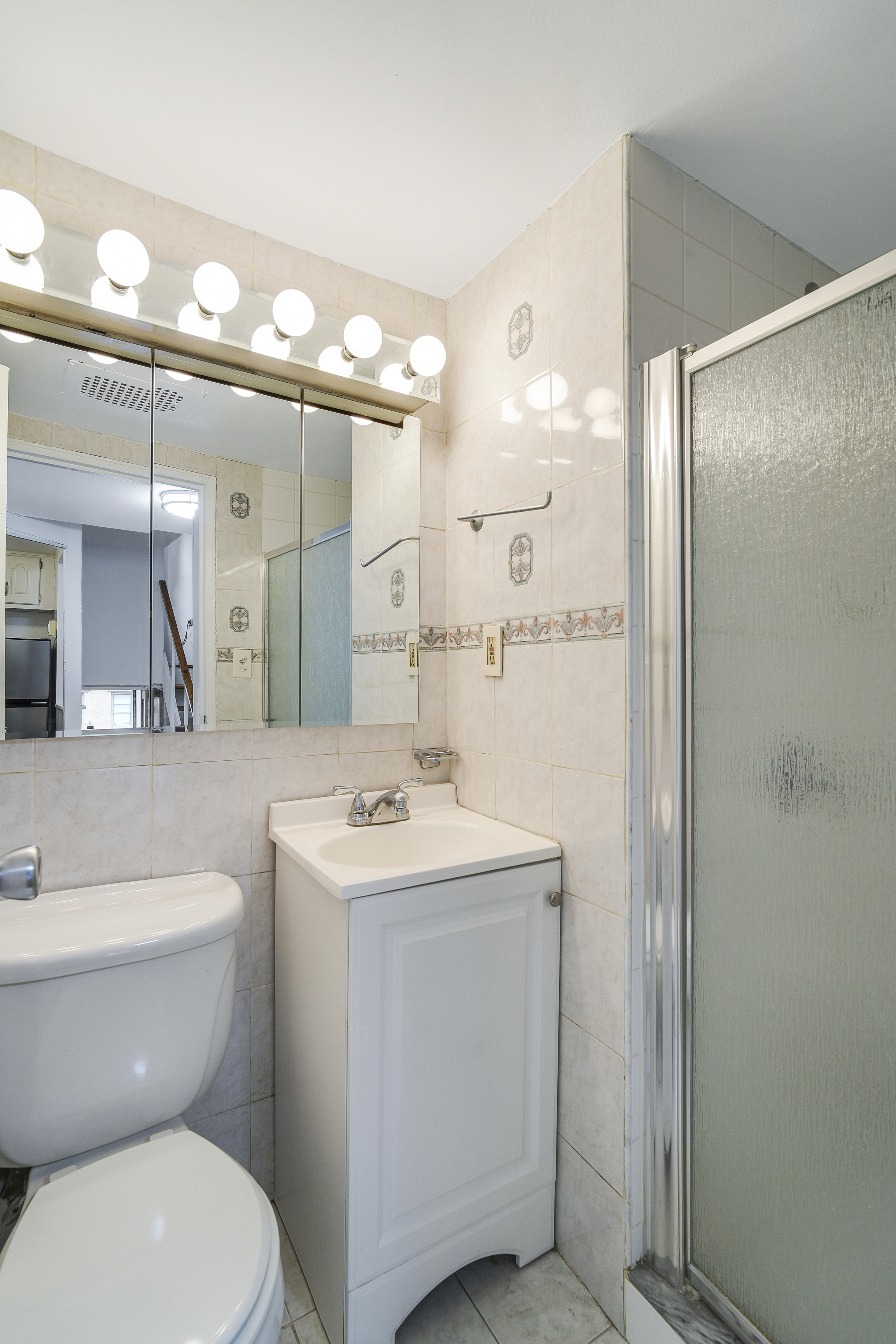 160 East 26th Street, Unit 5F Manhattan, NY 10010 - Photo 8 of 10 a bathroom with a toilet sink and mirror