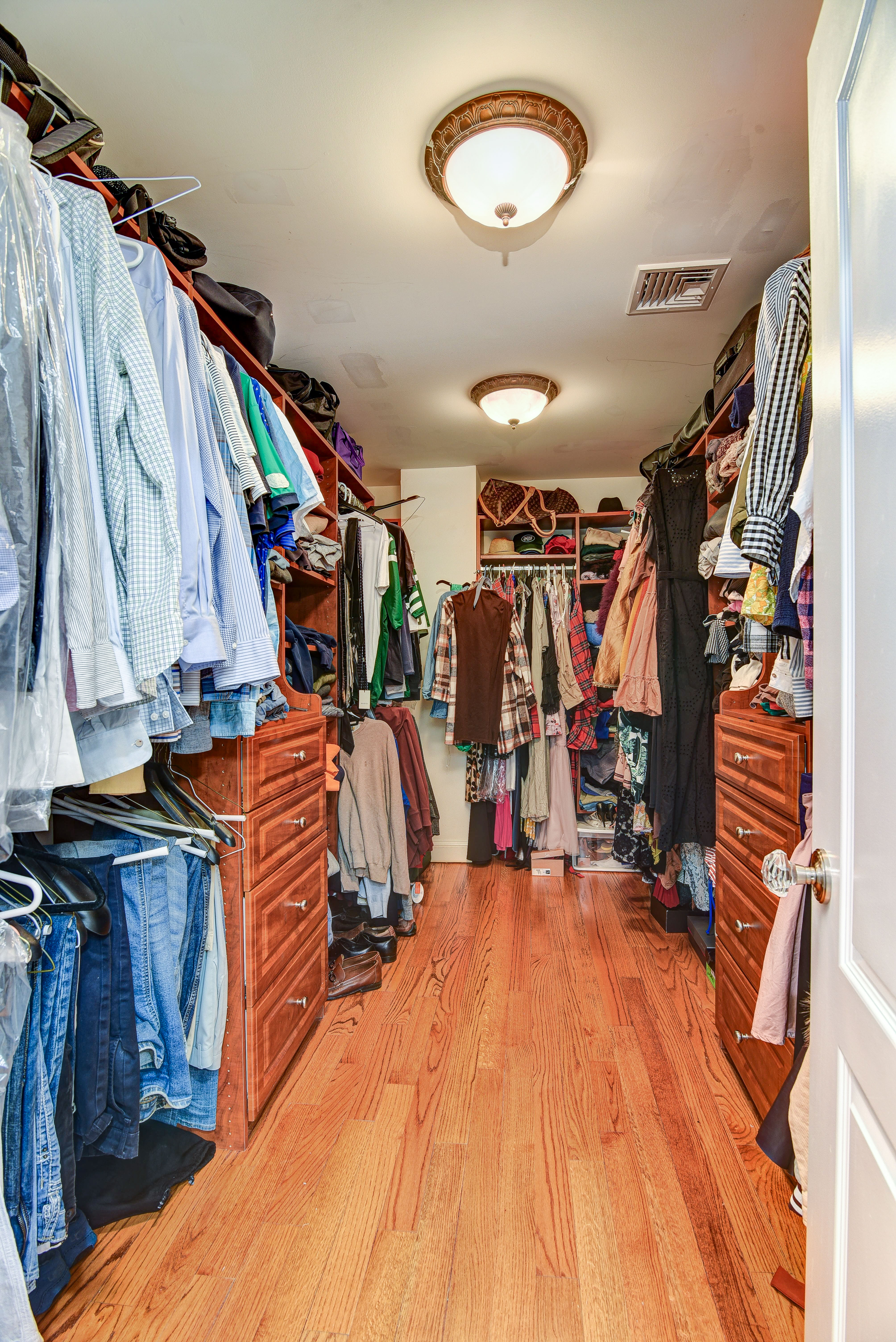 215 Lawrence Avenue Staten Island, NY 10310 - Photo 20 of 45 a view of walk in closet with clothes and shoes