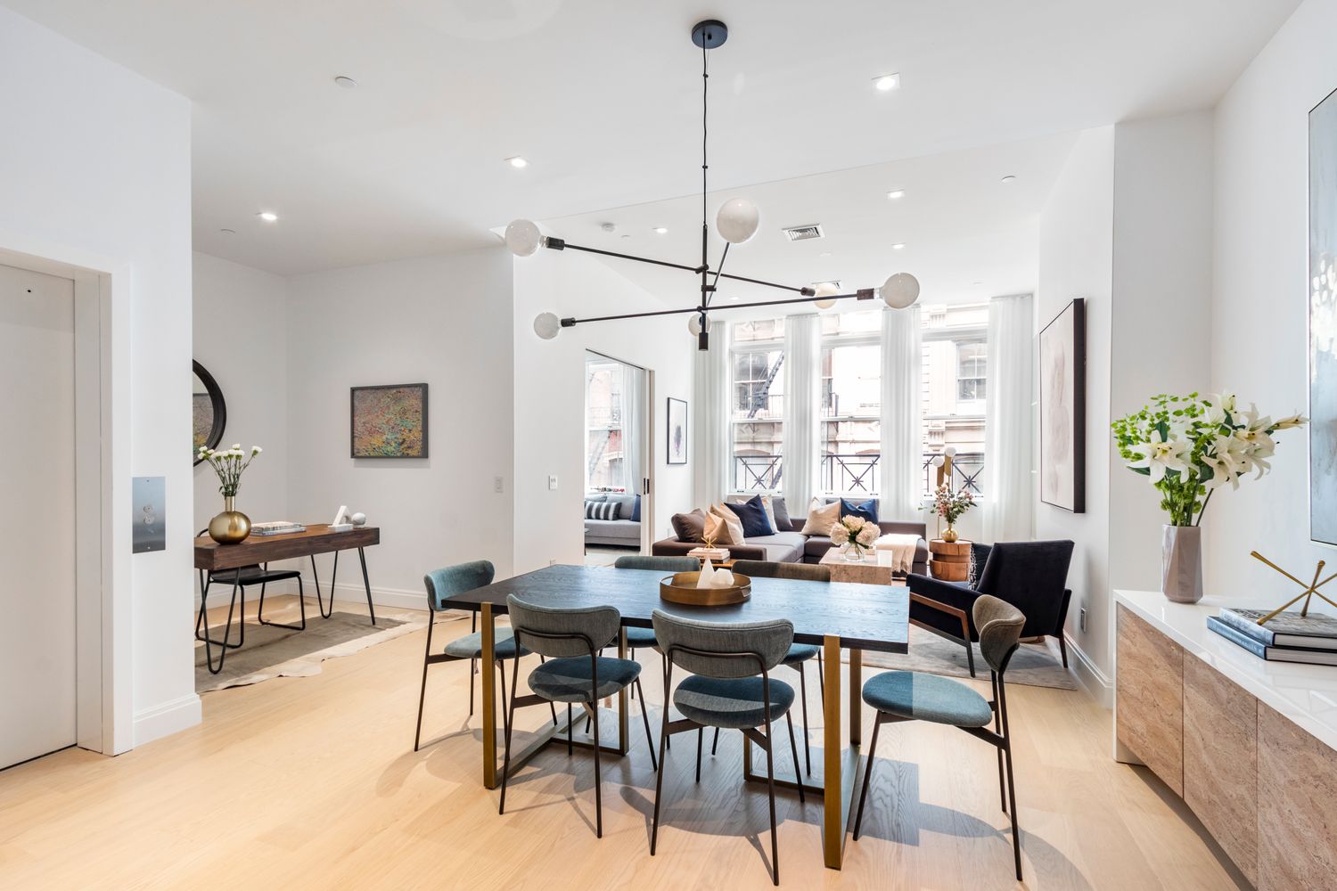 106 Franklin Street, Unit 2 Manhattan, NY 10013 - Photo 4 of 16 a dining room with furniture a chandelier and wooden floor
