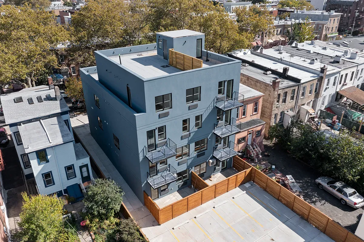 an aerial view of multiple houses with yard
