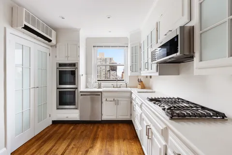 a kitchen with stainless steel appliances a white stove top oven and sink