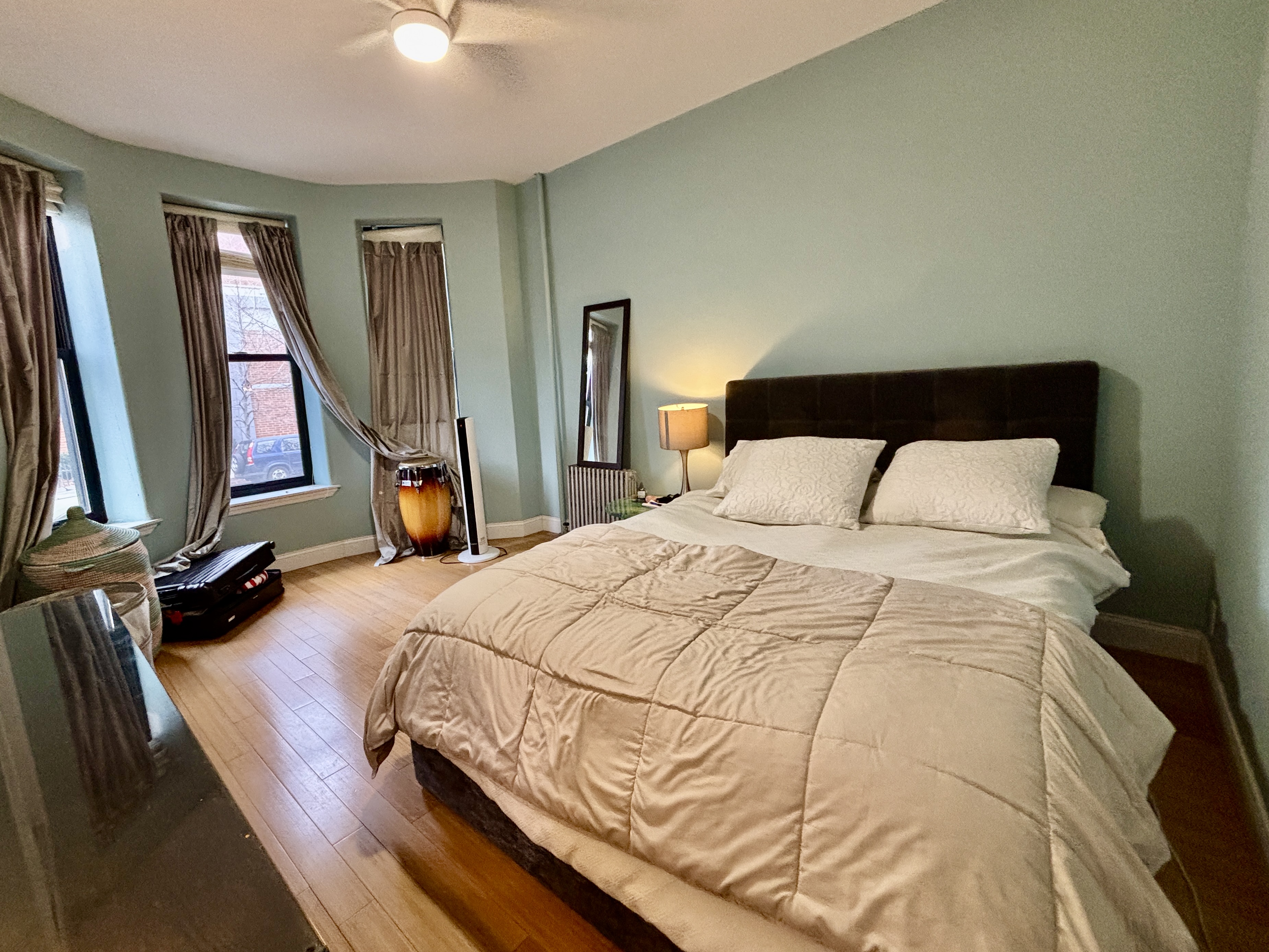 848 Macon Street, Unit PARLOR Brooklyn, NY 11233 - Photo 3 of 10 a bedroom with a bed mirror and window