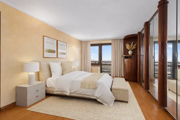 a bedroom with a large bed and a window