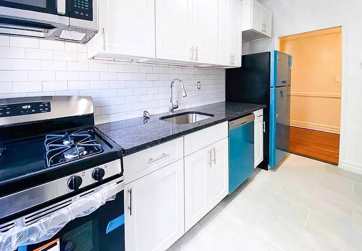a kitchen with stainless steel appliances granite countertop a stove and a refrigerator