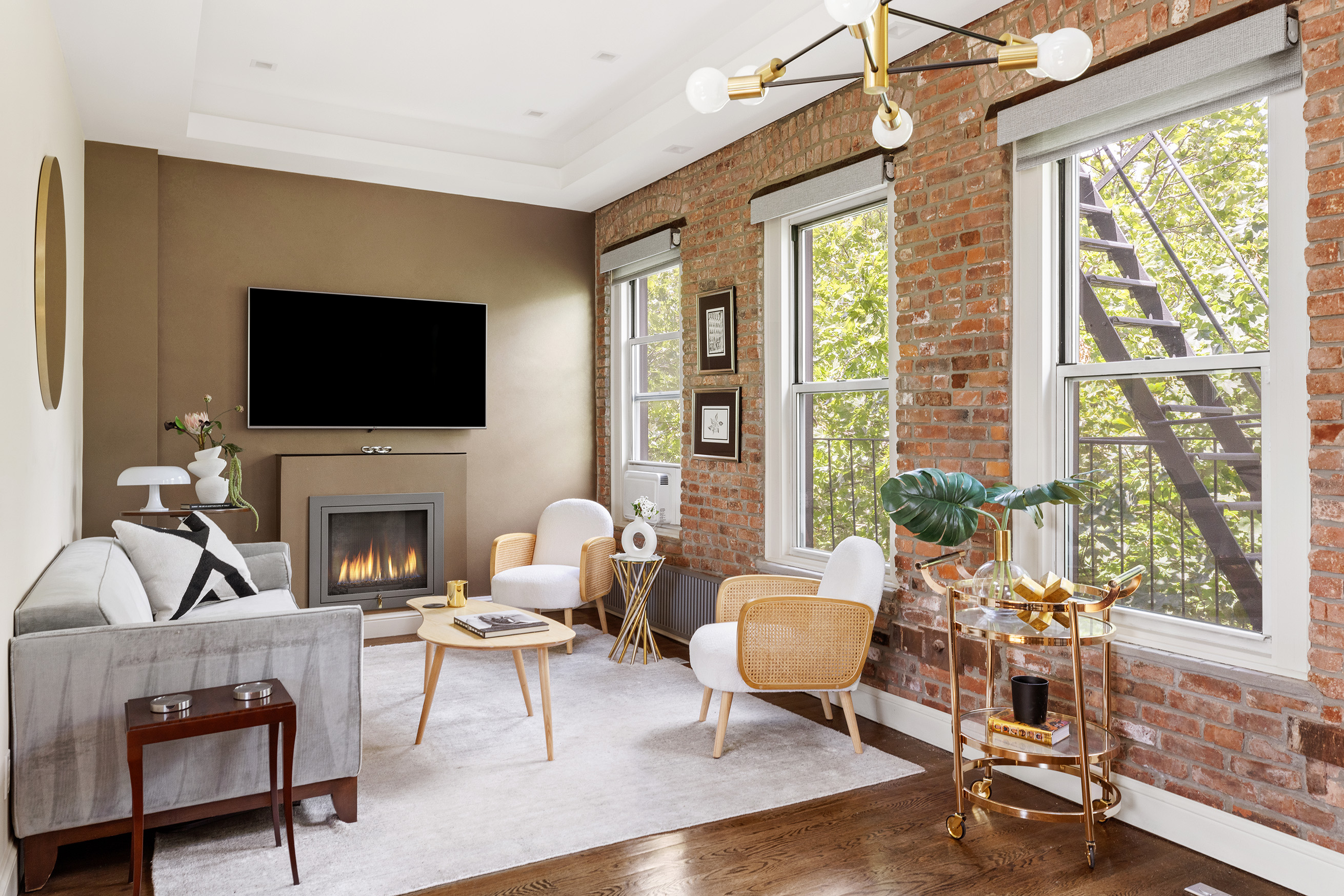 77 Perry Street, Unit 6CD Manhattan, NY 10014 - Photo 3 of 16 a living room with furniture a flat screen tv and a large window